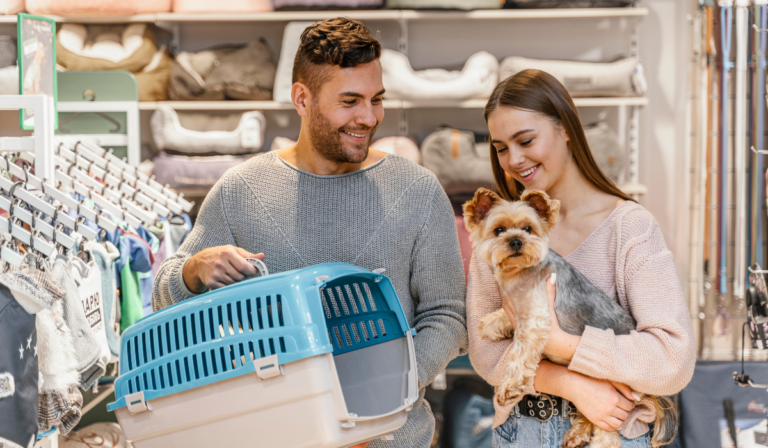 couple carry their dog in shopping